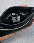 Black 5 card wallet made from vegan cactus leather with subtle piping detail on edge, showing middle pocket