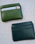 Two card wallets in nopal green and dark forest green with 5 card pockets made from vegan cactus leather with subtle piping detail on edge