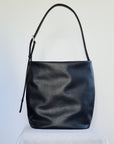 Large bucket tote made from cactus leather with an adjustable buckle strap