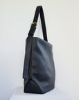 Cactus leather tote back with curved bottom panel, and adjustable buckled strap
