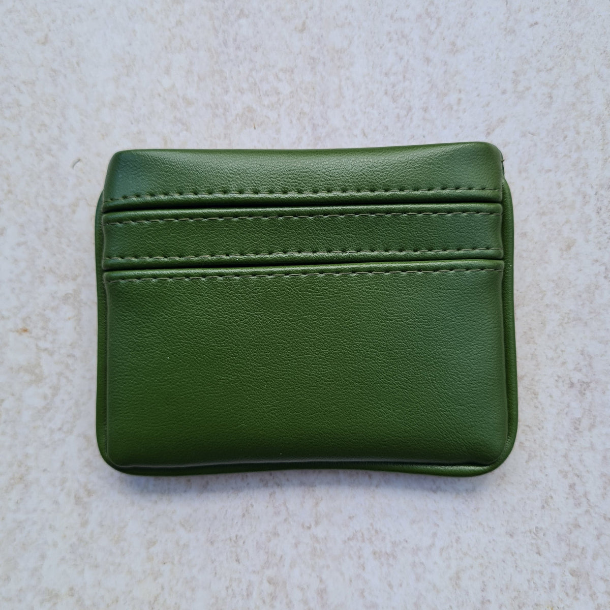 Green 5 card wallet made from vegan cactus leather with subtle piping detail on edge