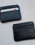 Two black card wallets in smooth and pebble texture, with 5 card pockets made from vegan cactus leather with subtle piping detail on edge