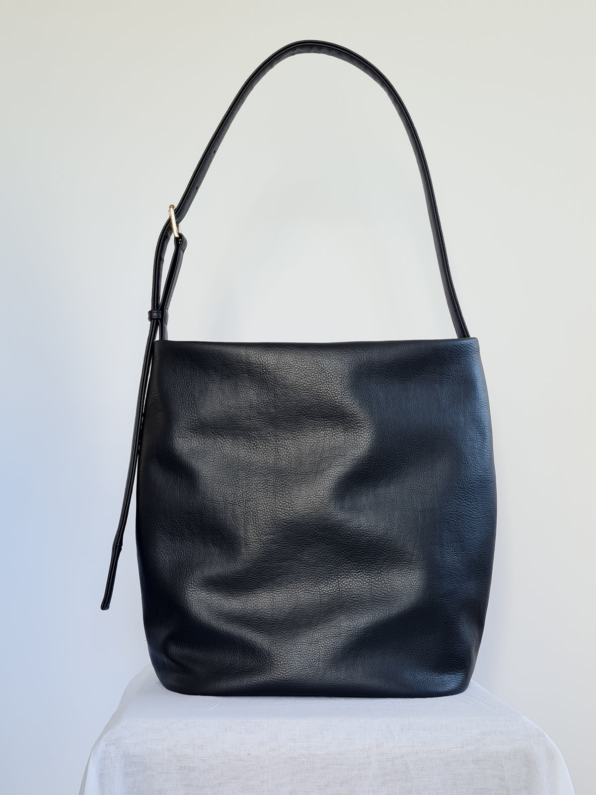 Large bucket tote made from cactus leather with an adjustable buckle strap