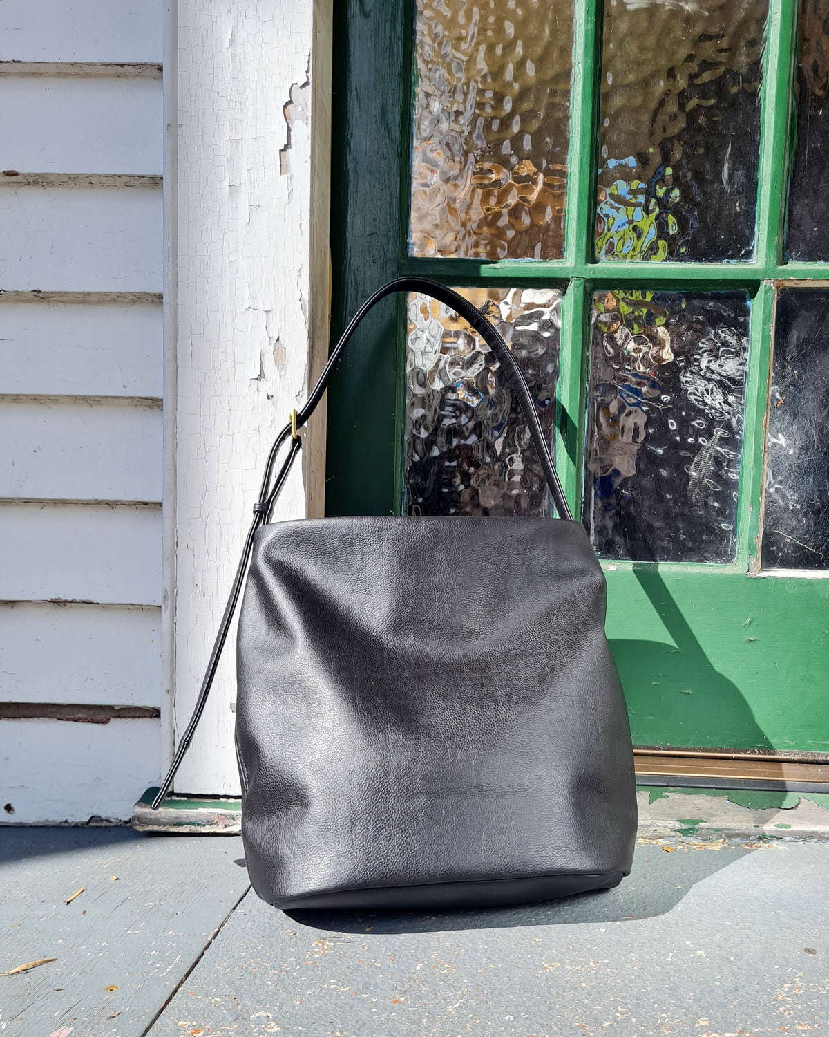 Large bucket tote made from cactus leather with an adjustable buckle strap