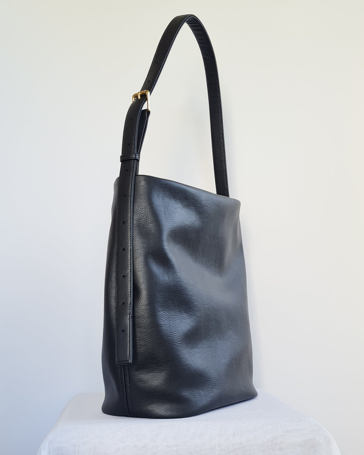 Large bucket tote made from cactus leather with an adjustable buckle strap