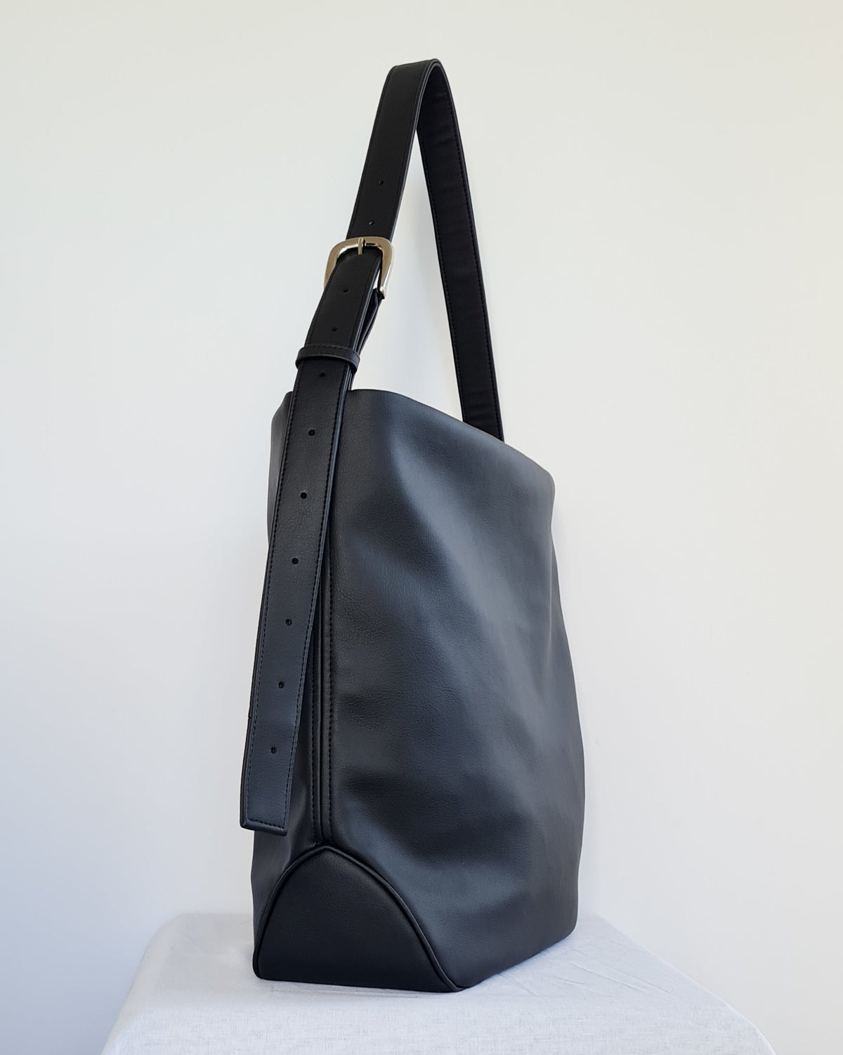 Cactus leather tote back with curved bottom panel, and adjustable buckled strap