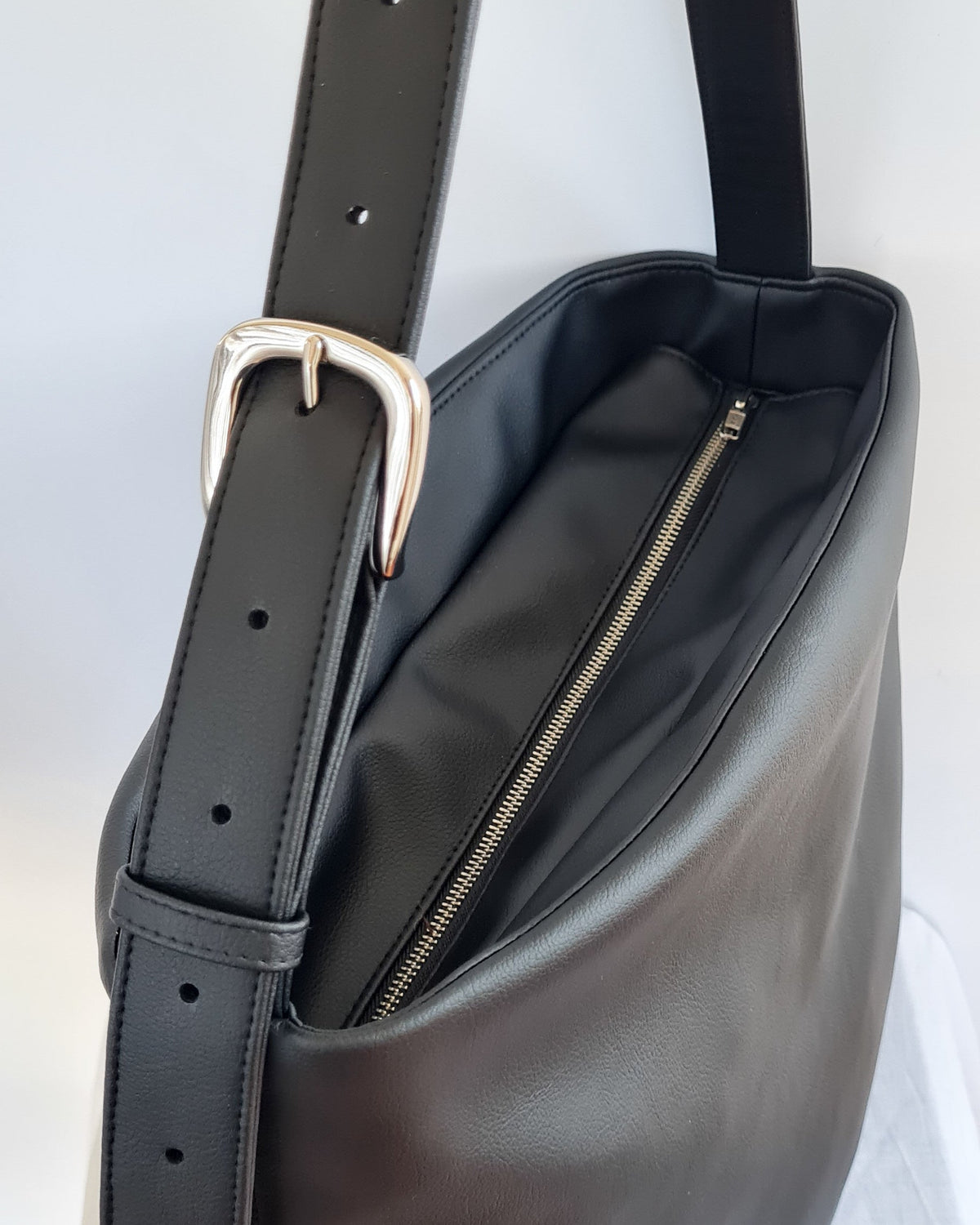Cactus leather tote back with curved bottom panel, and adjustable buckled strap