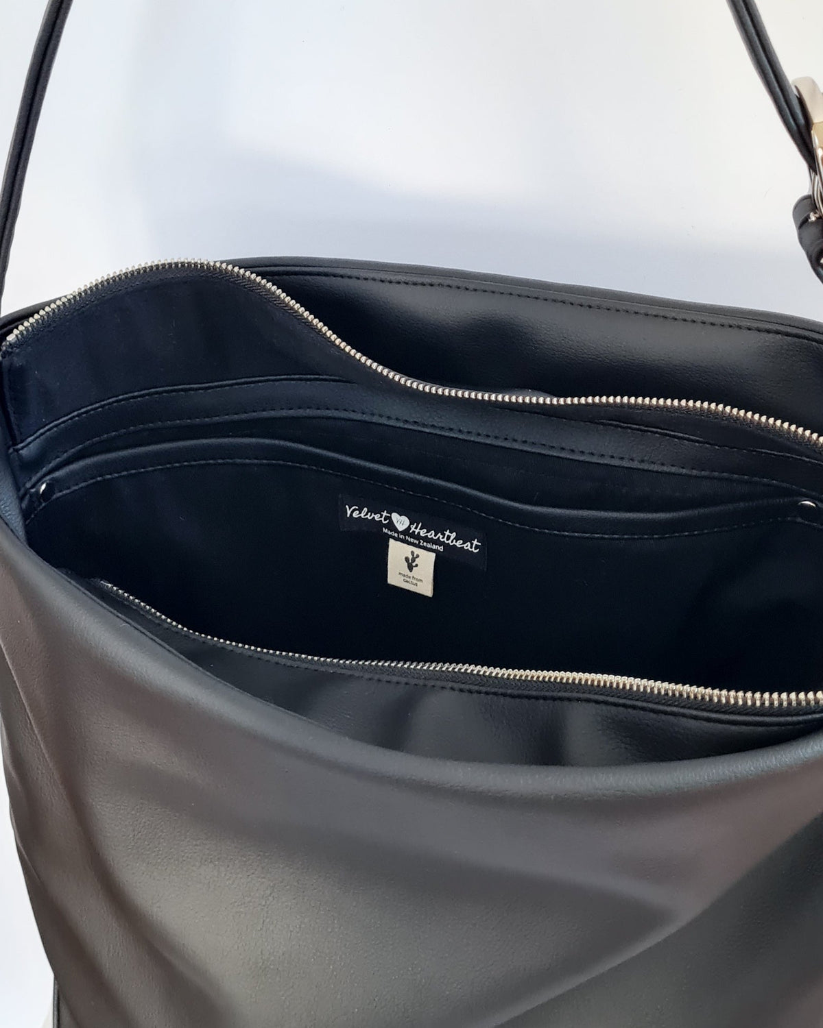 Cactus leather tote back with curved bottom panel, and adjustable buckled strap
